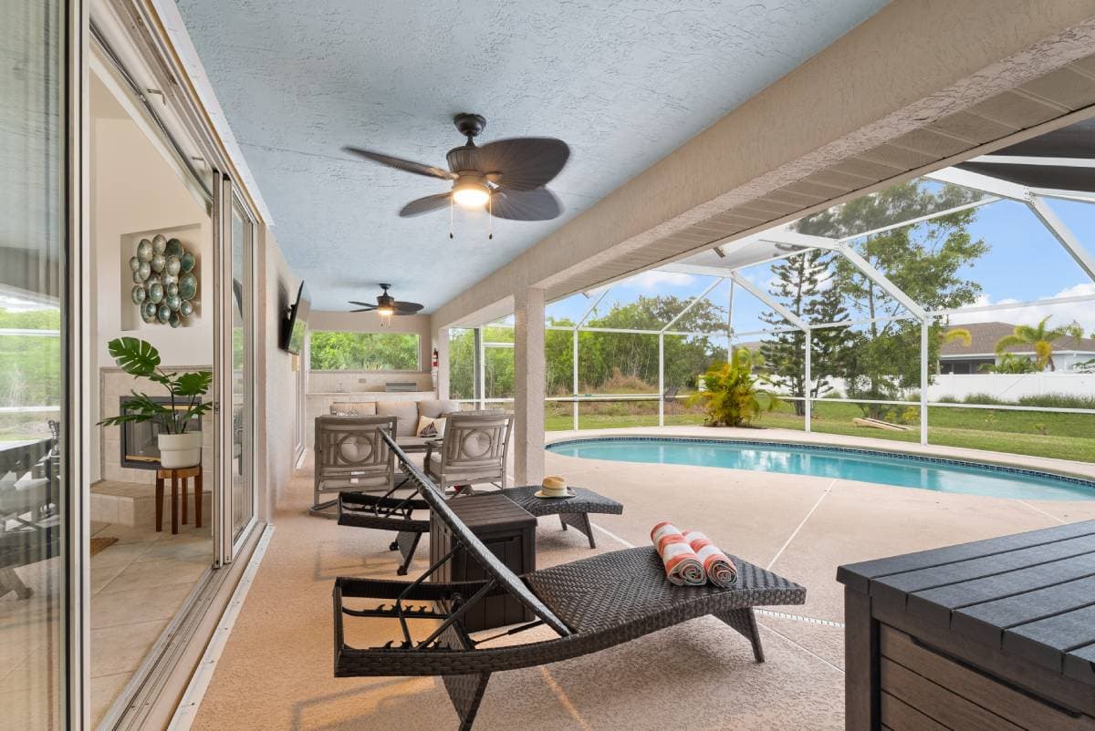 Pool deck with lounge chairs and tropical landscaping